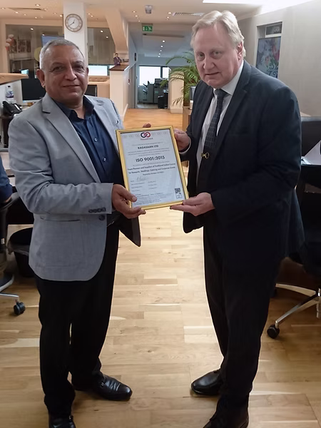 Certification team presenting an ISO certificate to a client organization